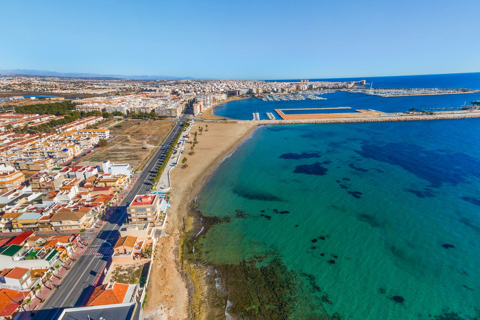 Playa Los Naufragos beach and harbor aerial view Torrevieja
